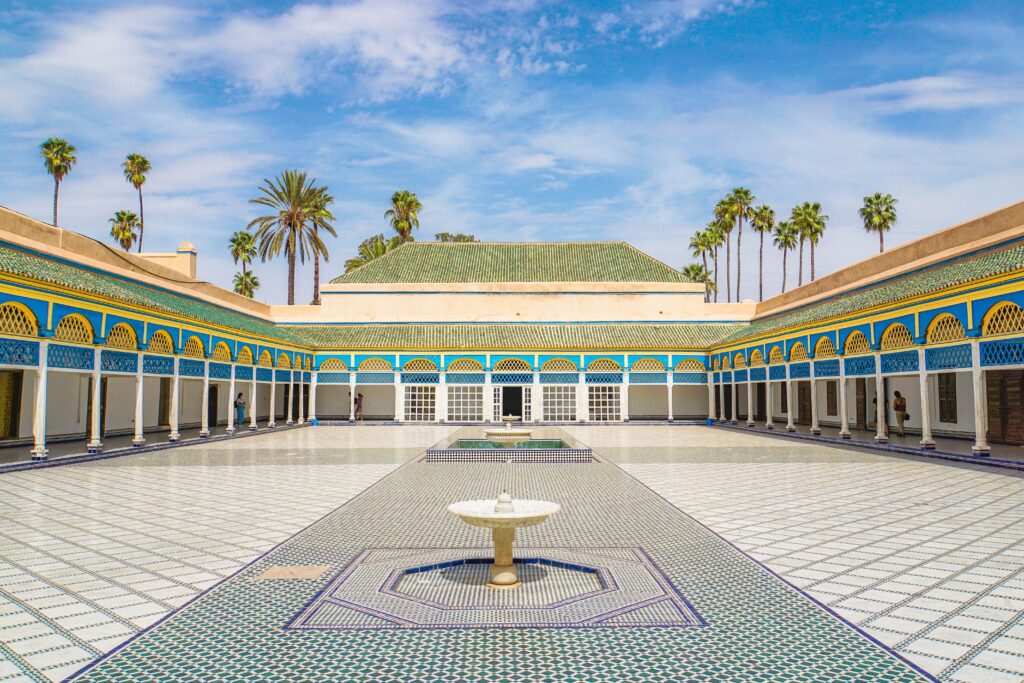 Bahia Palace courtyard with mosaic tiles and palm trees, Marrakech
